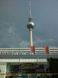 Low angle view of communications tower against sky