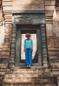 Full length of tourist visiting ancient temple