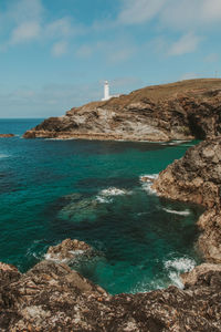 Scenic view of sea against sky and a lighthouse on the coast