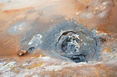 Hverir geothermal area in iceland, boiling volcano mud pot red ground, geothermal alternative energy