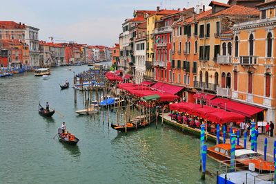 Boats in river with buildings in background