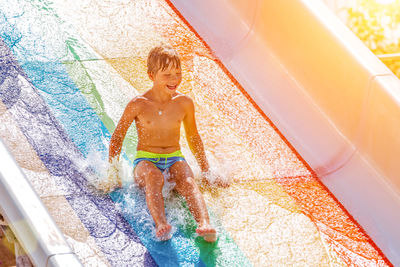 Full length of smiling man in swimming pool