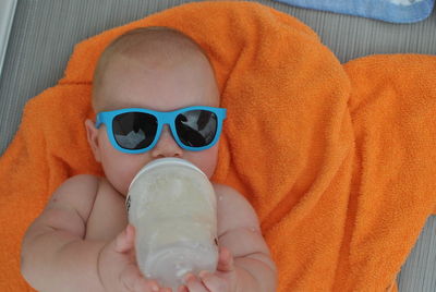 High angle view of baby drinking milk from bottle