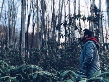 Side view of person standing in forest