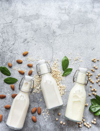 Bottles with different plant milk - soy, almond and oat milk.