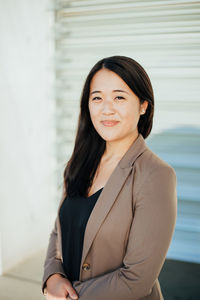 Portrait of smiling businesswoman standing in office