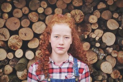 Portrait of girl against logs