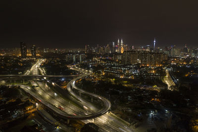 High angle view of illuminated city buildings at night