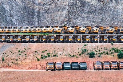 Trucks parked against mountain