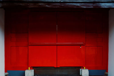 Close-up of red door of building