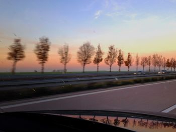 Cars on road at sunset