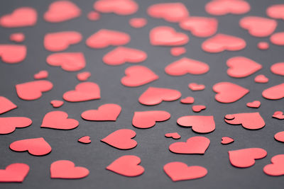 High angle view of heart shape on pink table