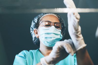 Close-up of surgeon wearing glove