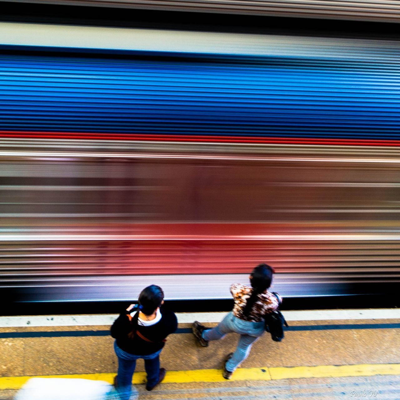 lifestyles, men, transportation, blurred motion, leisure activity, illuminated, motion, full length, indoors, person, childhood, casual clothing, night, boys, railroad station platform, on the move, rear view, travel