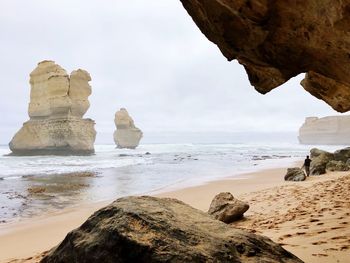 Rocks on beach against sky