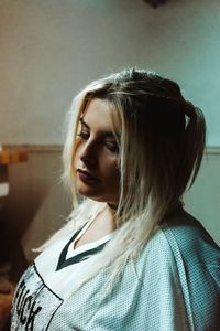 Portrait of woman standing against wall