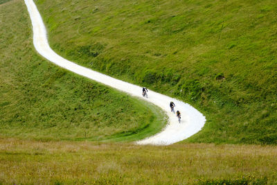 High angle view of people riding bicycle on road