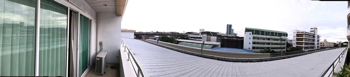 Panoramic view of modern buildings against clear sky