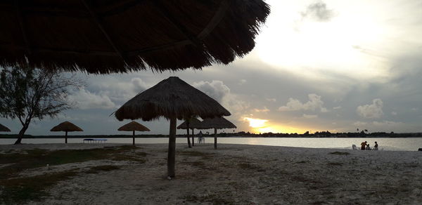 Scenic view of beach against sky during sunset