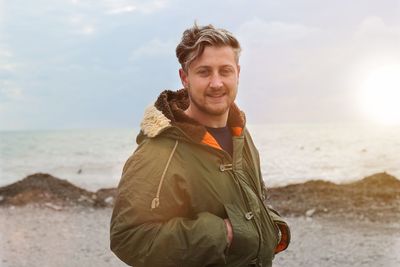 Portrait of man standing at beach