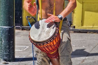 Midsection of man playing instrument