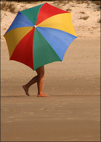 Low section of woman walking on beach