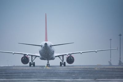 Winter day at the airport. airplane taxiing to runway at snowing.