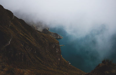 Scenic view of mountains against cloudy sky