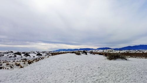 Scenic view of snow covered landscape against sky