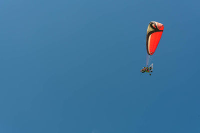 Low angle view of hot air balloon against clear blue sky