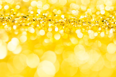 Defocused image of illuminated yellow background