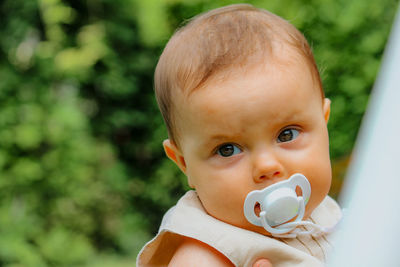 Close-up of cute baby with pacifier