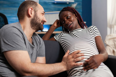 Man touching stomach of pregnant woman