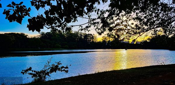 Scenic view of lake against sky during sunset