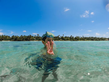 Little kid snorkeling in a maldive islands