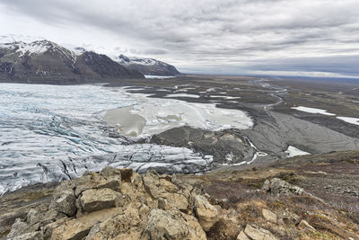 Scenic view of mountains and glacier against sky