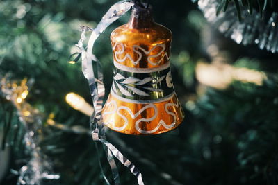 Close-up of bell hanging on christmas tree