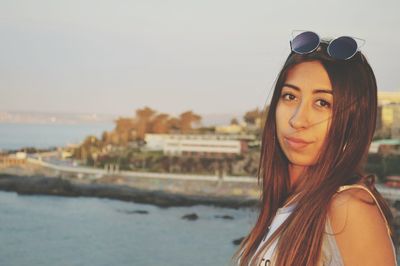 Portrait of young woman wearing sunglasses at beach