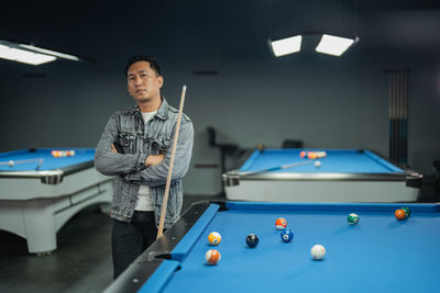 Portrait of man playing pool