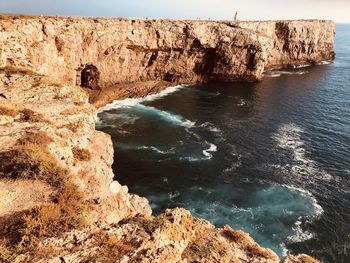 High angle view of rocks on sea shore