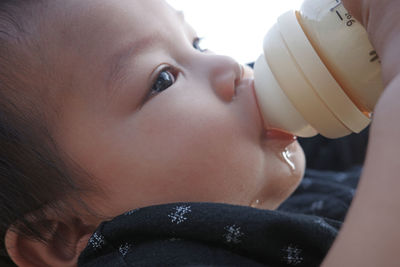 Close-up of young woman drinking water