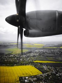 Airplane flying over landscape against the sky