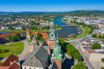 High angle view of townscape by river in city