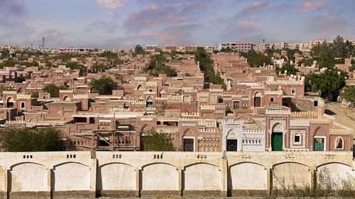 Buildings in town against sky