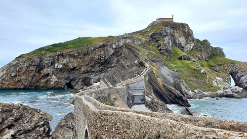 Scenic view of sea and rock formation against sky