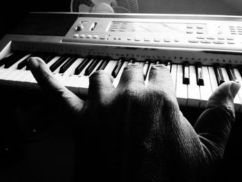 Close-up of man hand on piano