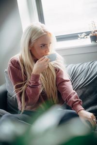 Young woman sitting at home