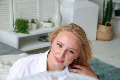 High angle view of woman with hand in hair