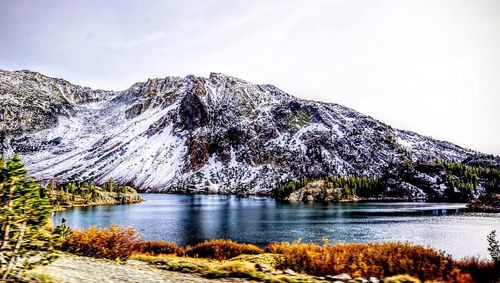 Scenic view of lake and mountains against sky