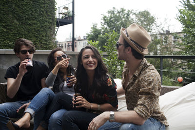 Cheerful friends sitting outdoors